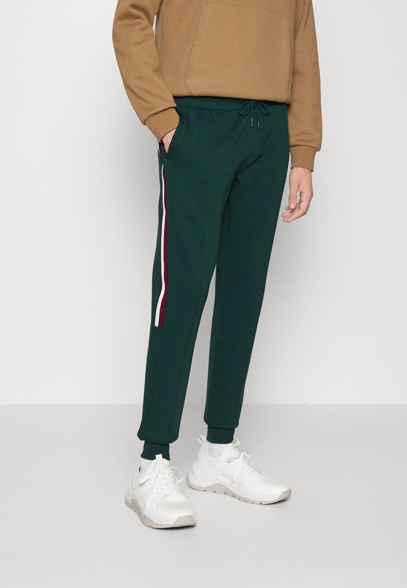 Tommy Hilfiger GLOBAL Tracksuit bottoms hunter/dark green Zalando