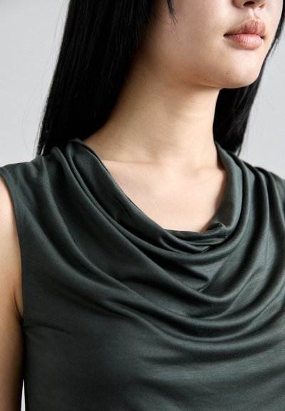 Dark green, sleeveless top with a draped cowl neckline. Smooth, lightweight fabric with subtle sheen. Focus on shoulder and neck area.