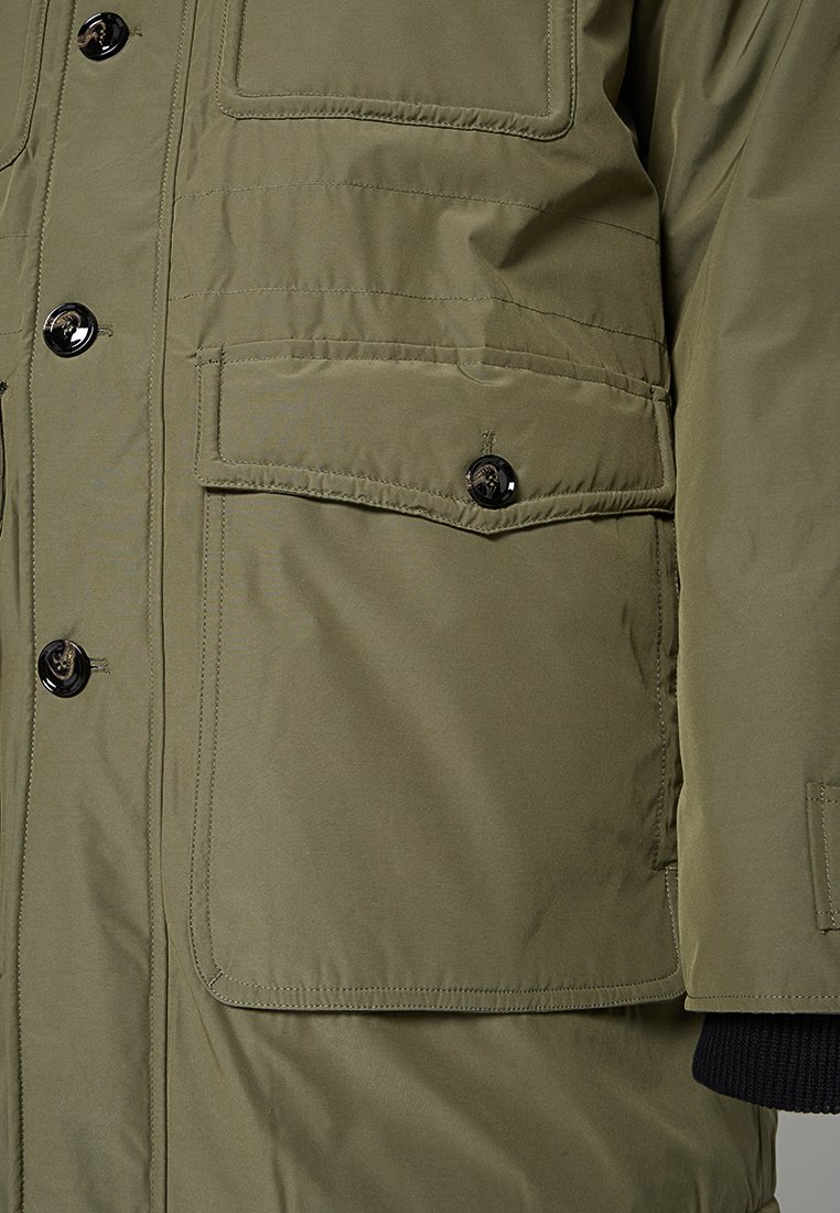 Zielonooliwkowa ocieplana kurtka z guzikami z przodu, dwoma kieszeniami z klapkami, ściągaczami przy mankietach i gładką, matową teksturą.