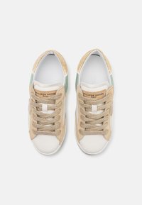 Beige and green sneakers with a textured upper, featuring gold accents, round toe, and lace-up design. Includes a brand label on the side.