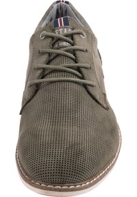 Scarpa in suede perforato verde oliva con punta rotonda, design con lacci, cuciture bianche a contrasto e fodera interna decorata con accenti rossi e blu.