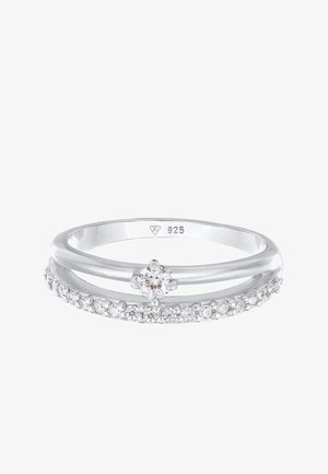 Anillo de plata de ley que presenta dos bandas, una con un diamante redondo central y la otra adornada con pequeñas piedras preciosas.