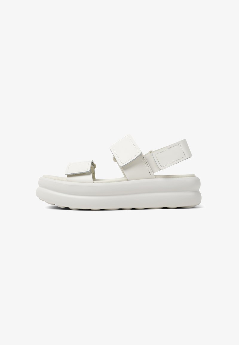Bílé platformové sandály se dvěma nastavitelnými suchými zipy. Vyrobené z hladkého syntetického materiálu. Měkké, zaoblené okraje s texturovanou podrážkou.