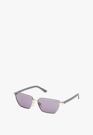 Gafas de sol hexagonales con lentes morados y acentos metálicos dorados. Patillas grises con grabado de la marca. Almohadillas nasales transparentes que ofrecen comodidad.