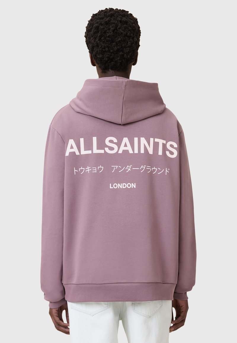 Felpa rosa polveroso con un grande logo bianco "ALLSAINTS" e testo giapponese sul retro. Presenta una vestibilità comoda e cappuccio con coulisse.