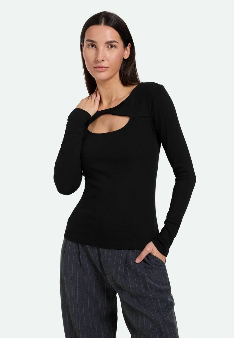 Schwarzes Langarmshirt mit einem ausgeschnittenen Ausschnitt, aus einem weichen Stoff gefertigt. Verfügt über ein tailliertes Design und eine glatte Textur. Kombiniert mit gestreiften Hosen.