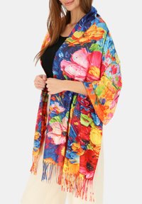 Kolorowy kwiatowy szal z mieszanką żywych kwiatów w odcieniach różu, pomarańczu i niebieskiego, z frędzlami na brzegach i luźnym, zwiewnym fasonem.