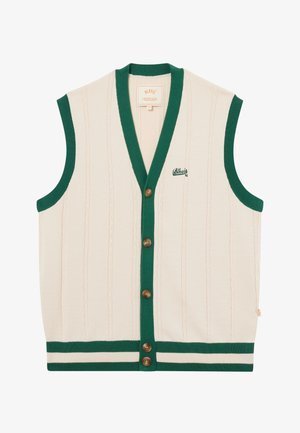 Veste en tricot sans manches crème avec bordure verte, fermeture à boutons, motif en câble vertical, et petit logo brodé vert sur le côté gauche de la poitrine.