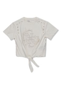 White cropped t-shirt featuring embroidered logo, knotted front hem, and decorative button accents on shoulders. Soft cotton material.