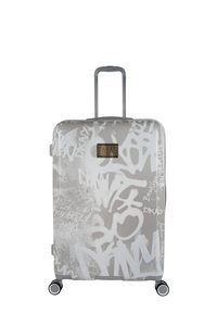 Maleta rígida en gris claro con estampado de grafiti blanco, asa retráctil y cuatro ruedas para facilitar la movilidad. Cuenta con un detalle metálico con la marca.