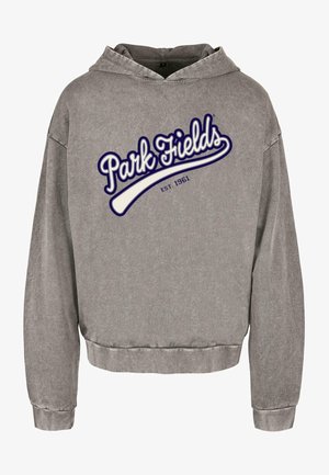 Sivá mikina s kapucňou a skráteným strihom. Obsahuje logo "Park Fields" v bielej a námorníckej farbe, založené v roku 1961. Mäkká textúra a dlhé rukávy.