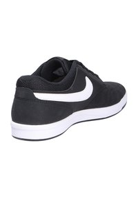 Black sneaker with a suede and mesh upper, white swoosh logo, padded collar, and a white rubber sole. Rear view highlighting its design.