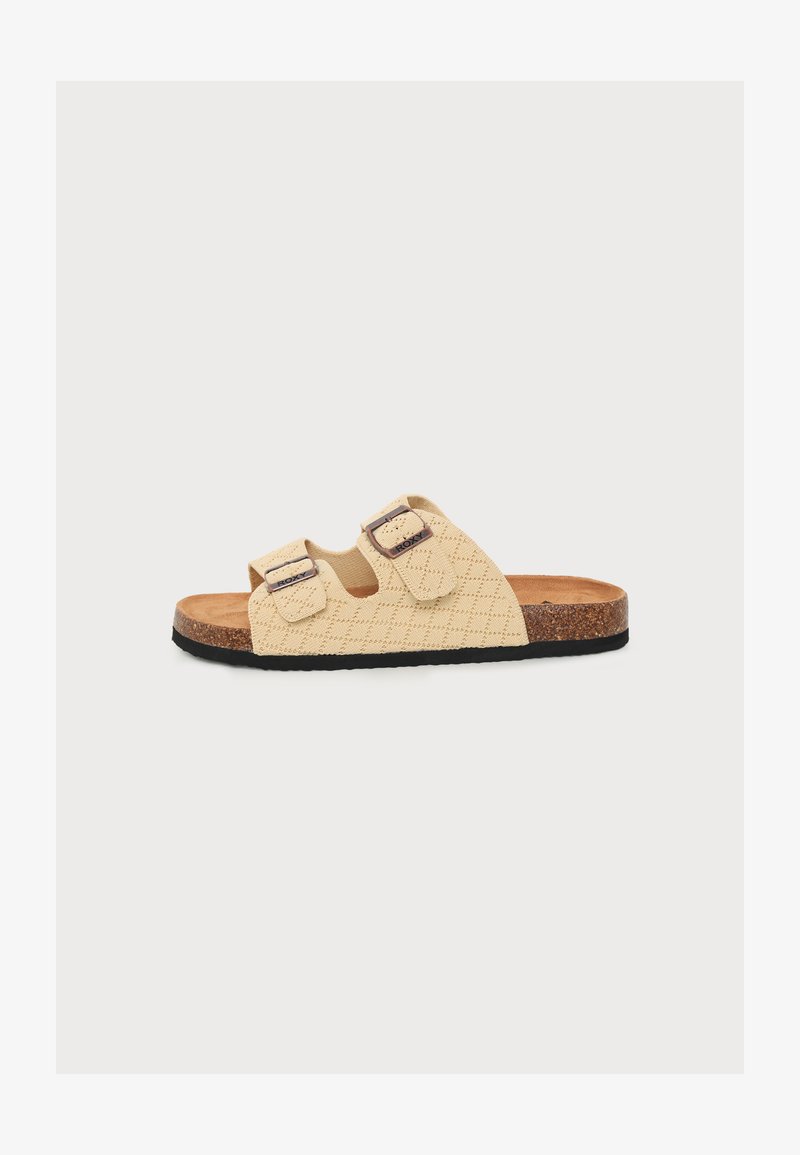 Sandale beige à enfiler avec deux brides ajustables, semelle en liège marron et semelle en caoutchouc noire.