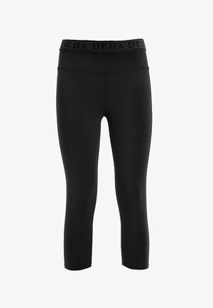 Schwarze Leggings aus elastischem Material, mit hohem Bund und einem strukturierten Logo-Band. In einer cropped Länge geschnitten mit glatten Nähten.