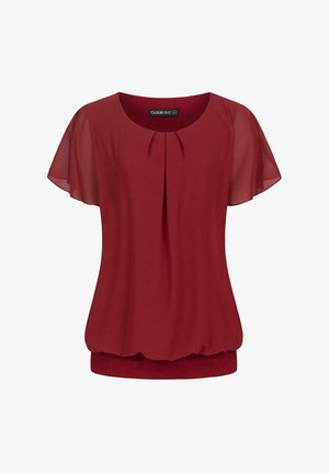 Blouse rouge avec des manches courtes et transparentes, devant plissé et ourlet froncé. Fabriquée en tissu léger, idéale pour le superposition.