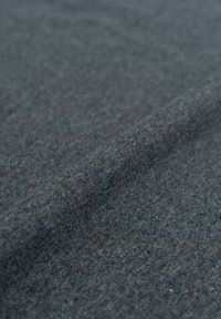 Gray fabric with a soft, textured surface. Slightly folded, showcasing a smooth finish and consistent color without patterns or accents.