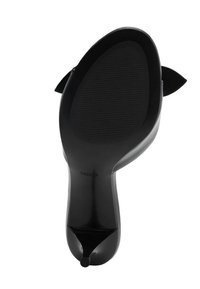 Black high-heel shoe with a pointed toe. The sole features a textured rubber surface, and a bow detail is on the back of the heel.