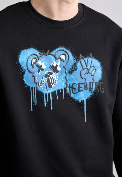 Sweatshirt noir avec un graphisme bleu représentant le visage d'un ours avec un design qui coule et le mot "ICEBORG", accompagné d'un symbole de paix.