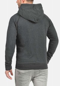 Dark gray hoodie with a soft texture, features a large hood and ribbed cuffs. Plain back with a lower hemline and no embellishments.