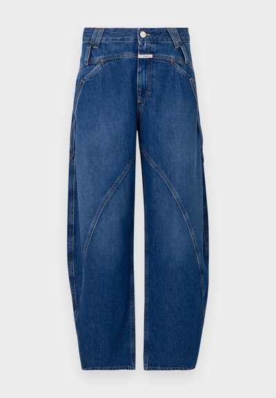 Blue denim wide-leg pants feature curved seams, a button closure, and contrasting stitching. The fabric has a classic smooth texture.