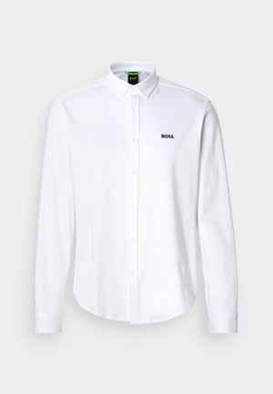 White button-up shirt made from cotton, featuring a classic collar and a subtle embroidered logo on the left chest. Smooth texture.