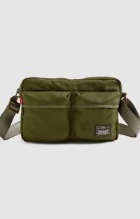 Olive green nylon crossbody bag with padded exterior, two front pockets, adjustable strap, and a small branded tag on the front.
