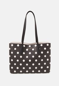 Borsa tote nera con pois bianchi, materiale testurizzato, doppi manici e parte superiore arrotondata. Logo "Kate Spade New York" centrato sulla parte anteriore.