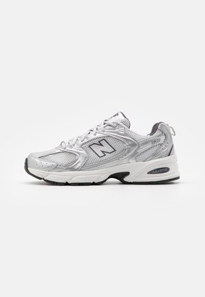 Silver and gray New Balance 530 sneaker with mesh upper, lace-up closure, and cushioned sole with ABZORB technology, shown in side profile.