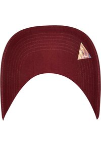 Maroon cap with a curved bill, made from textured fabric. Features a small holographic triangle logo on the underside of the bill.