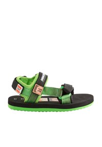 Groene en zwarte sandalen met meerdere verstelbare riemen, voorzien van een gestructureerde zool en een karakteraccent op de riem.