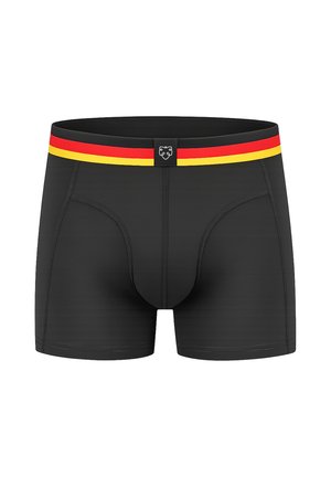 Fekete férfi boxeralsó piros és sárga csíkos derékrésszel és kis fekete címkével, középen elöl fehér oroszlán logóval.