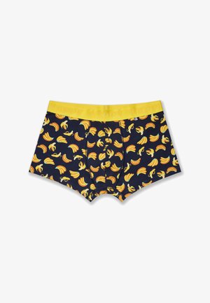 Men's boxer briefs in navy blue fabric featuring a banana pattern. Yellow elastic waistband with "HAPPY" text. Smooth texture and fitted shape.