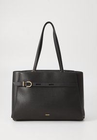 Black leather tote bag with two top handles, featuring a gold buckle accent and a textured finish. Logo embossed at the bottom.