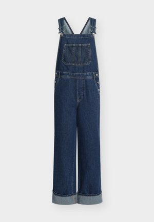 Denim tuinbroek met wijde pijpen, donkerblauwe kleur, verstelbare bandjes, voorvak en zilverkleurige hardware details. Omgeslagen zomen aan de onderkant.