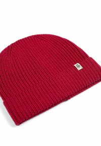 Red knitted beanie hat featuring a ribbed texture and a folded cuff. Includes a small logo patch on the side.