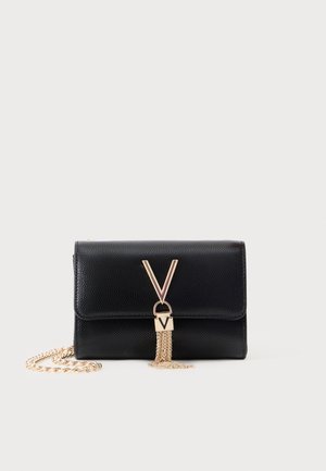 Black textured leather clutch with gold V-shaped clasp and chain tassel detail, accompanied by a detachable gold chain strap.
