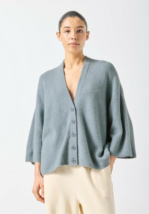 Light gray cardigan with a V-neck, wide sleeves, and five buttons down the front; made of textured knit fabric.
