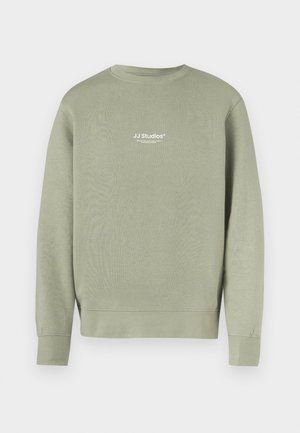Olive green sweatshirt made of soft fabric, featuring a crew neck, ribbed cuffs, and a small white logo on the front.