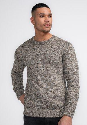 Maglione in maglia testurizzata nei toni della terra, con scollatura a girocollo e polsini a coste. Vestibilità casual con un motivo di colore leggermente sfumato.