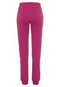 Fuchsia Sweatpants mit elastischem Bund, schmal zulaufenden Bündchen und Seitentaschen. Aus weichem, dehnbarem Stoff für optimalen Tragekomfort.