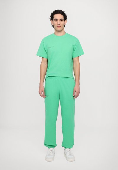 Sæt i mintgrøn bestående af en T-shirt og sweatpants, lavet af blødt bomuld, med en afslappet pasform og elastiske manchetter på bukserne.