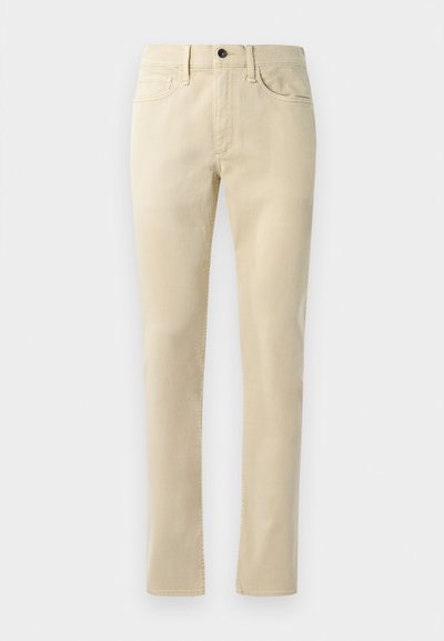 Beige suorat housut, jotka on valmistettu puuvillasekoitteesta. Ominaisuuksiin kuuluu viisi taskua, vyölenkit ja musta nappi vyötäröllä.