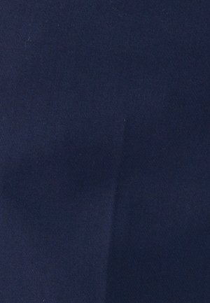 Dark blue fabric with a subtle vertical crease and fine texture visible across the surface.