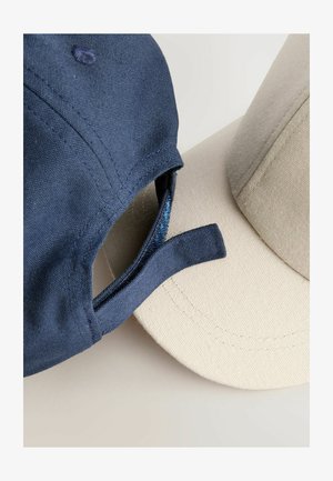 Zwei Kappen sind ausgestellt: eine marineblaue mit strukturiertem Stoff und verstellbarem Riemen sowie eine beige mit glatter Oberfläche und runder Krone.