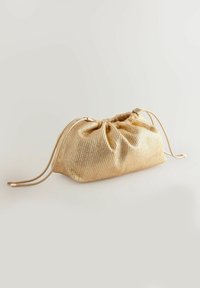 Gold, textured drawstring bag with a gathered top and smooth cords, featuring a structured yet soft shape, ideal for lightweight carry.