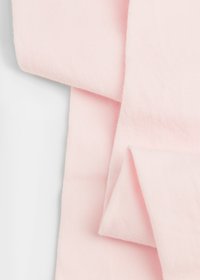 Tessuto rosa chiaro con un motivo testurizzato a coste, composto da strati piegati che mostrano una superficie liscia e una sensazione morbida.