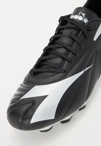 Black football boot made of synthetic leather with a metallic silver design, featuring a lace-up closure and textured accents.