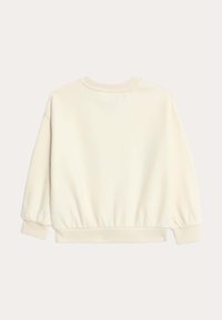 Cremefarvet sweatshirt med ribbet kant og ærmer. Blød tekstur, dropped shoulders og rund halsudskæring; ensfarvet bagview.