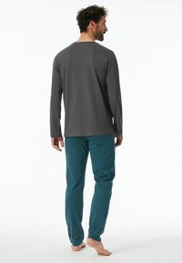 Gray long-sleeve shirt with a round neckline, paired with teal patterned pajama pants featuring a subtle design.