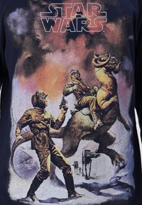 Dark navy T-shirt featuring a vintage-style Star Wars graphic with two figures and a creature, detailed in bold colors and soft texture.